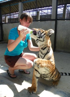 Ms Malik with Coledo the tiger at Samutprakan Crocodile Farm and Zoo in Thailand in about 2011.