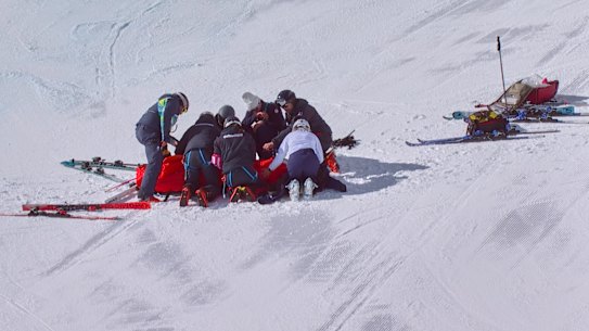 Medics attend to Lindsey Vonn on the slope after her crash.