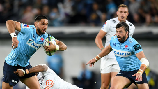 Losing cause: Curtis Rona tries to break the Sharks defence.