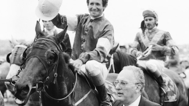  Co-owner, Dennis Gowing, leads Melbourne Cup winner, What a Nuisance with jockey Pat Hyland. 