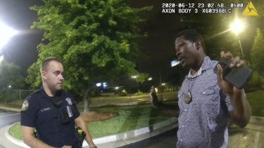 An image taken from police body camera footage showing Rayshard Brooks speaking with officer Garrett Rolfe.