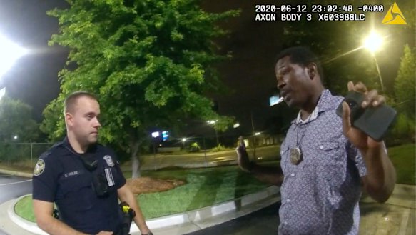 An image taken from police body camera footage showing Rayshard Brooks speaking with officer Garrett Rolfe.