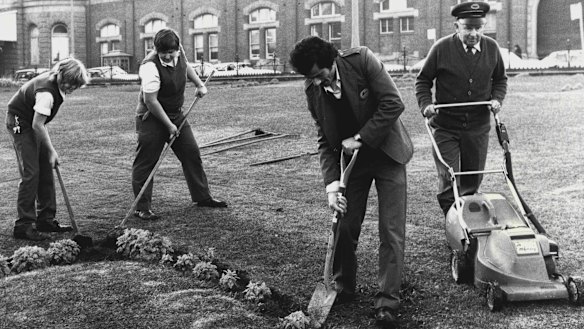 Keeping busy ... As the strike entered it's seventh day, station attendants worked on the gardens at Central Railway Station yesterday.