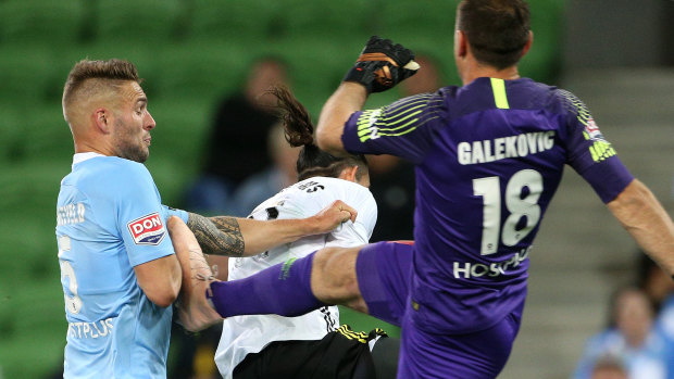 Friendly fire: Bart Schenkeveld of Melbourne City is kicked in the arm by his goalkeeper Eugene Galekovic.