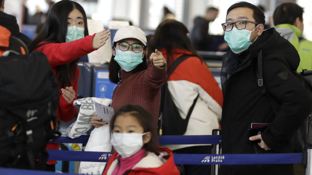 Passengers wearing masks before a flight to Shanghai from Vaclav Havel International Airport in Prague, Czech Republic.