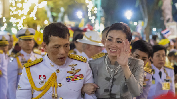 King Maha Vajiralongkorn and Queen Suthida wave to supporters in Bangkok, Thailand.
