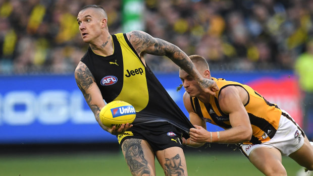 Thirst for ball: Dustin Martin (left) evades Hawthorn's James Worpel.