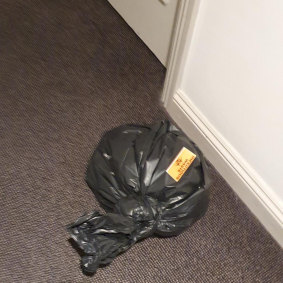 A bag left in a corridor at the Rydges on Swanston marked "infectious waste".