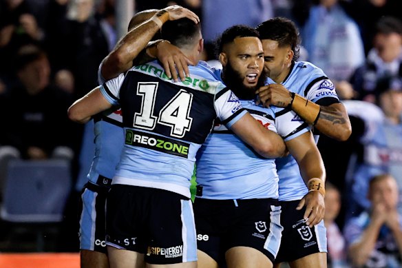 The Sharks celebrate a try.