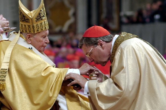 Cardinal George Pell kisses Pope John Paul II’s hand during a Mass at the Vatican in 2003.