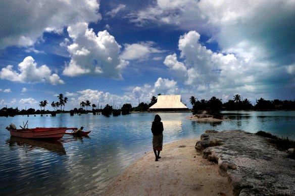 On the Pacific island of Abaiang, people must use a boat to cross from one side of a village to another at high tide as the sea creeps further in.