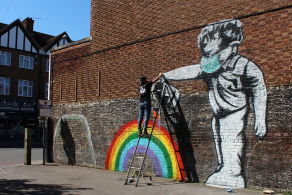 Street artist Chris Shea works on his 100th 'Rainbow Boy' artwork in West Wickham, south London. Forty-eight per cent of Britons have been "accepting" of the lockdown.