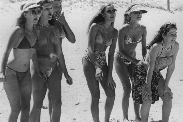 The surfie chicks in the Greenhills Gang watch their guys surf in a scene from the 1981 film Puberty Blues.