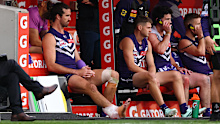 Alex Pearce of the Dockers sits on the bench with ice on his Achilles. 