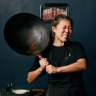 Emily Yeoh with a larger version of the $15 wok she recommends from Yuen’s in Brisbane, or a similar Asian grocery store.