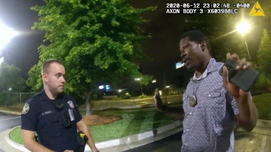 An image taken from police body camera footage showing Rayshard Brooks speaking with Officer Garrett Rolfe.