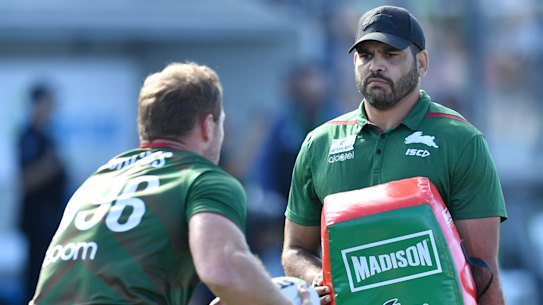 Sidelined: An injured Greg Inglis holds the pads at Souths training at Sunshine Coast Stadium. 