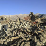 People stand by damaged houses after the earthquake in Tonglai village, in Xigaze, south-western China’s Tibet Autonomous Region on Tuesday.