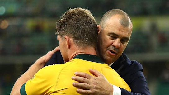 Emotional time: Michael Cheika and Michael Hooper embrace after Australia's loss to England.