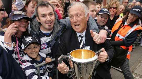 Frank Costa is mobbed by fans in 2007 after Geelong’s premiership.