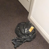 A bag left in a corridor at the Rydges on Swanston marked "infectious waste".