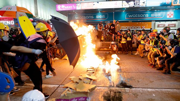 Protesters burn cardboard to form a barrier in a stand-off with police in Hong Kong.