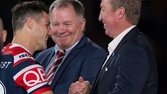 Broken wing: Cooper Cronk is congratulated by Trent Robinson – with his good arm.
