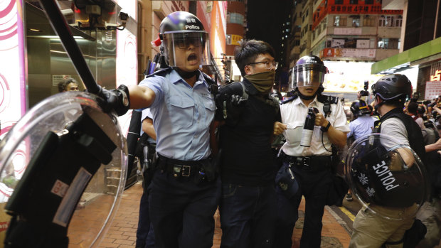 Police officers take away a protester in Hong Kong on Sunday.