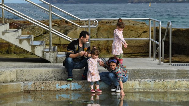 Tony and Gena Been with their daughters Winona, 5, and Daisy, 2, at the children’s pool at Bondi Beach.