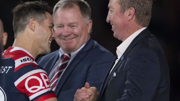 Broken wing: Cooper Cronk is congratulated by Trent Robinson – with his good arm.
