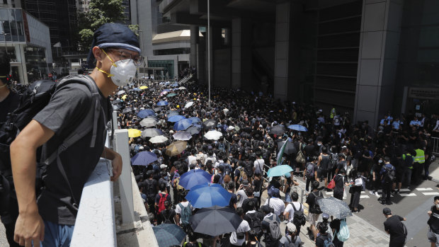 Protesters surround the police headquarters in Hong Kong on Friday.