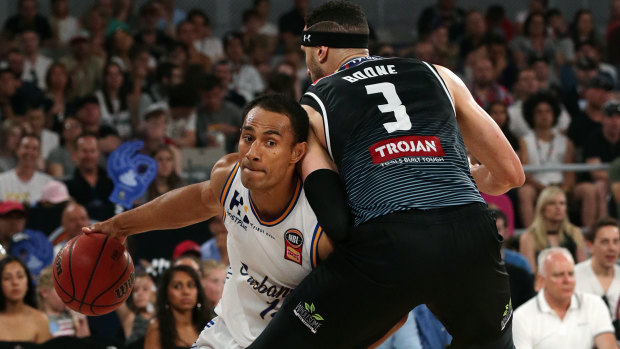 Solid defence: Mika Vukona of the Brisbane Bullets try to get around Melbourne's Josh Boone.
