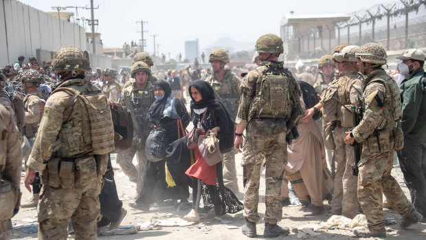 US and British troops evacuate Afghans amid chaotic scenes outside the airport in Kabul.