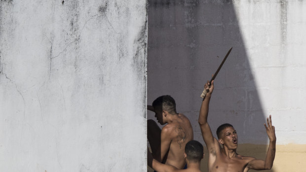 Gangs have a lot of sway in Brazil's prisons. Here, inmates display a makeshift knife moments after police left the prison in the Alcacuz prison in Nisia Floresta, near Natal, Brazil during an uprising in 2017.