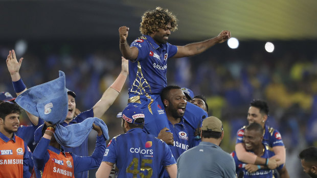 Sneaking home: Lasith Malinga is carried by his teammates after they secured another IPL title.