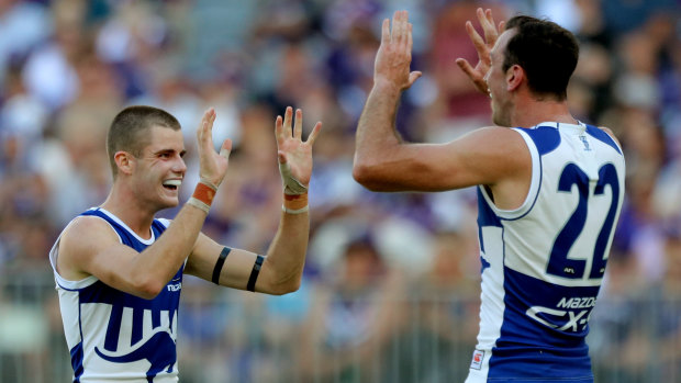 Off the mark: Bailey Scott (left) celebrates with Todd Goldstein after scoring for North Melbourne on debut.
