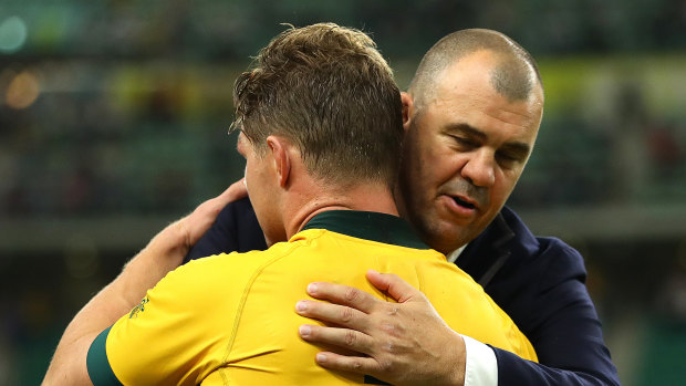 Emotional time: Michael Cheika and Michael Hooper embrace after Australia's loss to England.