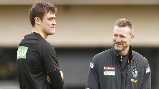 Injured Magpie Darcy Moore (left) with coach Nathan Buckley.