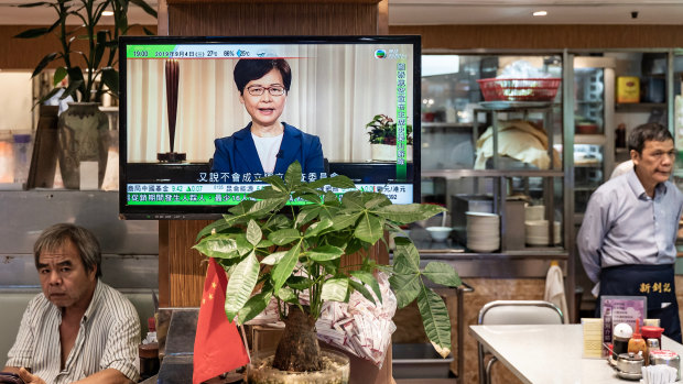 A television replays Hong Kong Chief Executive Carrie Lam announcing the formal withdrawal of the extradition bill inside a restaurant in Hong Kong, China. 