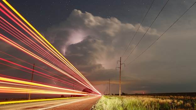 Truck lights blast past as storms continue in Texas and Oklahoma.