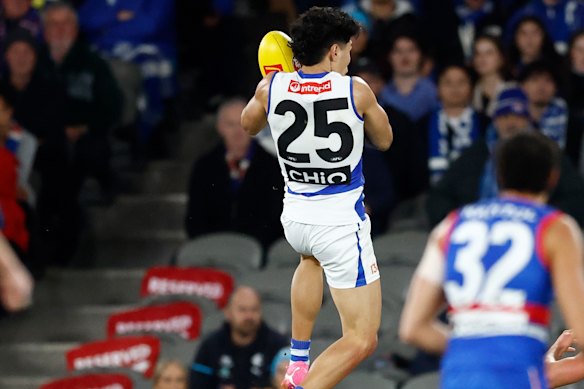 Paul Curtis of the Kangaroos takes a spectacular mark.