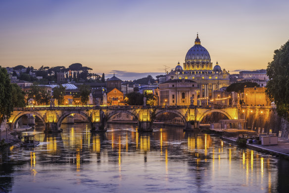 Looking over the Tiber River to St Peter’s Basilica at sunset.