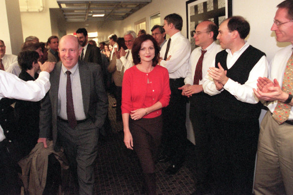 Jeff Gerth, left, and Maureen Dowd are congratulated as they walk through the New York Times newsroom after the announcement that they won Pulitzer Prizes in 1999. 