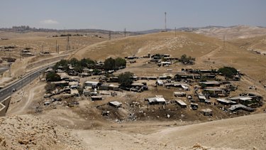 The Bedouin village of Khan Al-Ahmar behind a highway that divides two bustling Israeli settlements in the West Bank last June.
