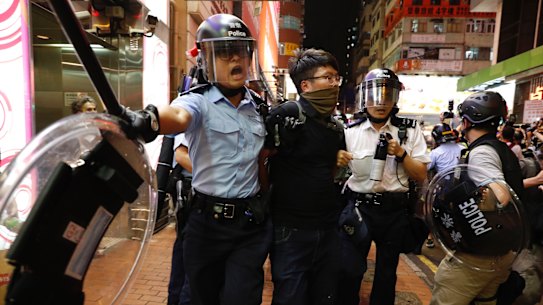 Police officers take away a protester in Hong Kong on Sunday.