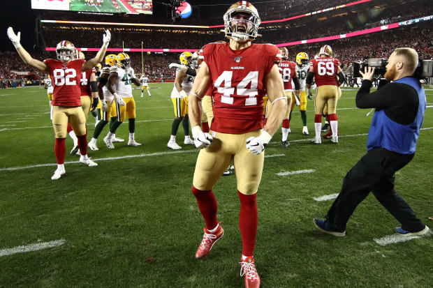 San Francisco 49ers players celebrate after qualifying for the Super Bowl by beating the Green Bay Packers.