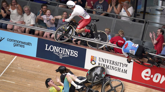 English cyclist Mall Walls (left) and Canadian Derek Gee crash in to the crowd during the men’s 15km scratch race qualifying round.
