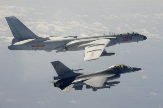 Tension in the skies. A Taiwanese F-16 flies near a Chinese bomber as it passes near Taiwan in 2020. 