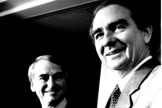 Tony Fitzgerald (right) handing his report to then-Queensland premier Mike Ahern in 1989.