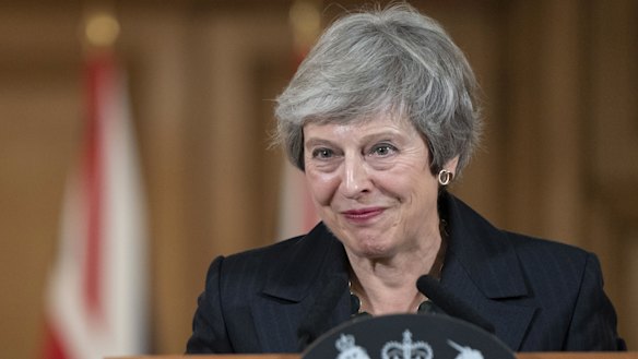 Theresa May listens to a question from reporters as she delivers a statement on the Brexit agreement during a news conference inside number 10 Downing Street in London.